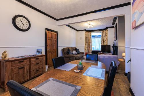 a dining room with a table and a living room at Londonderry House in Stockton-on-Tees