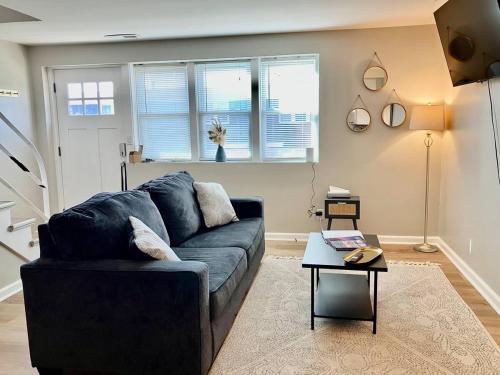 a living room with a couch and a table at Davenport Dwellings-Two Bedroom Close to UNMC in Omaha