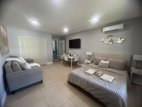 a bedroom with a bed and a couch and a table at Peaceful Florida Studio in Lakeland