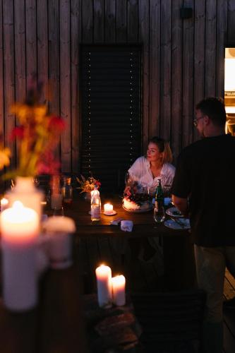 a group of people sitting at a table with food at Chalupa Nadohled in Červený Potok