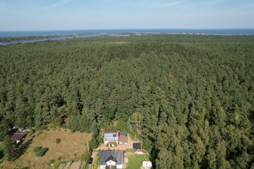 an aerial view of a house in the middle of a forest at UROCZYSKO POD LASEM in Nickelswalde
