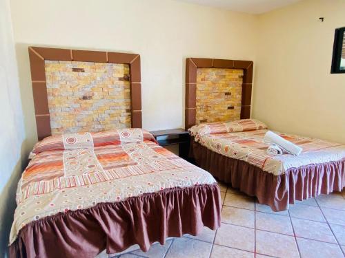 Cama o camas de una habitación en Hotel Sta Cruz Oaxtepec