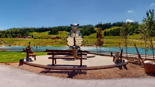 a statue of a bear sitting on a bench at Royal Queen Suite Pool-Spa Ski-in out Gym, Sauna, Laundry, BBQ in Brian Head
