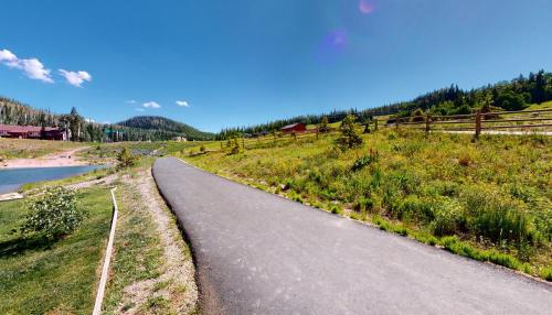 a road in a field next to a river at Royal Queen Suite Pool-Spa Ski-in out Gym, Sauna, Laundry, BBQ in Brian Head