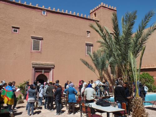 a crowd of people standing outside of a building at Hotel Tomboctou in Tinerhir