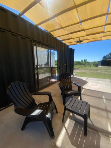 two chairs and a bench on a patio at containers house in San Rafael