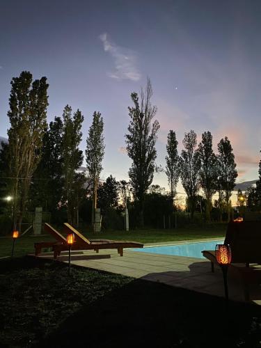 a swimming pool with two benches and a picnic table at containers house in San Rafael