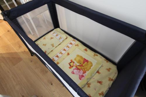 a bed with a teddy bear blanket on it at La Dolce Vita Civitavecchia in Civitavecchia