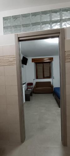 a room with a door leading to a bedroom with a bed at All inBasilicata Bed & Breakfast in Baragiano
