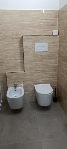 a bathroom with a toilet and a bidet and a sink at All inBasilicata Bed & Breakfast in Baragiano