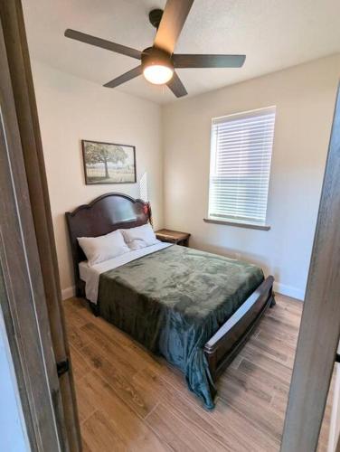 a bedroom with a bed with a ceiling fan at Willis Country Cabins-Sunset-#2 in Point