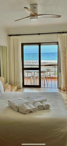 a bedroom with a bed with a view of the ocean at T1 Vista Baía Monte Gordo in Monte Gordo