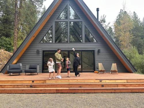 a family standing on a deck in front of a house at Luxury Escape in McCall in McCall