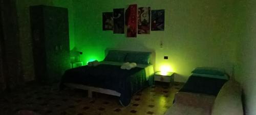 a bedroom with a green room with a bed and a lamp at All inBasilicata Bed & Breakfast in Baragiano