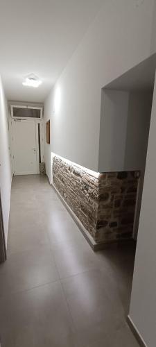 an empty room with a brick wall and a door at All inBasilicata Bed & Breakfast in Baragiano