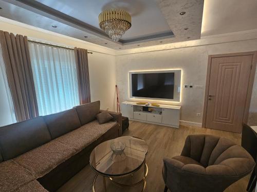 a living room with a couch and a tv at Montain House Rakocevic in Kolašin