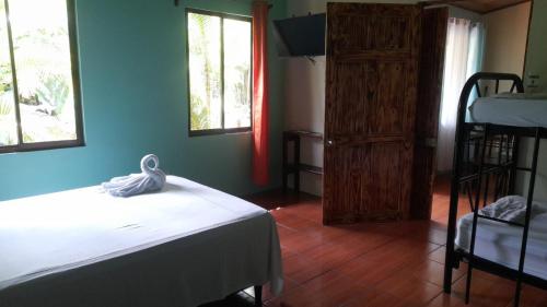 a bedroom with a bed and a ladder and a window at Cabañas Río Escondido en La Fortuna in Fortuna