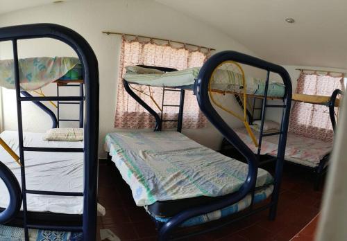 a room with three bunk beds in a room at Villa ilusiones in Grecolandia