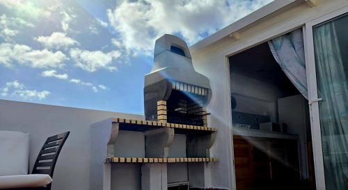 a wall with a painting of a rocket at Casa Naya in Famara