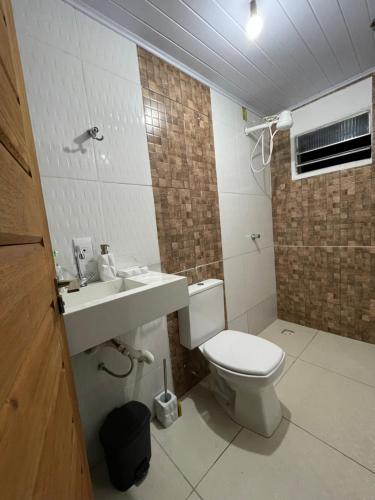 a bathroom with a toilet and a sink at KitNet em Caraíva-Nova Caraíva in Caraíva