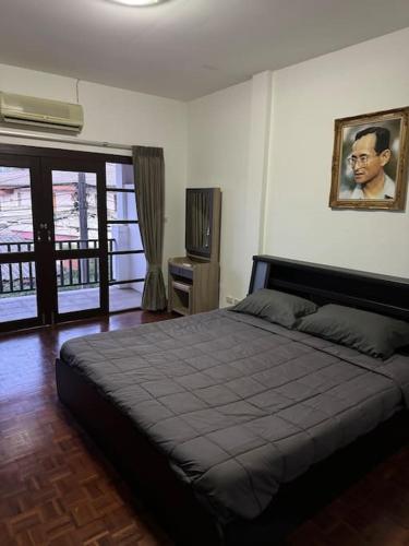 een slaapkamer met een groot bed en een televisie bij 2 Bedroom Townhouse in Koh Samui 