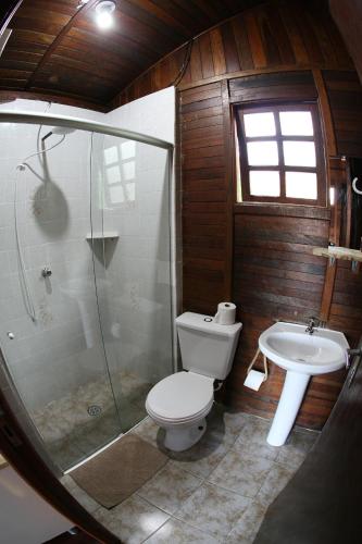 a bathroom with a toilet and a sink at Chalé Heliconia in Juquitiba