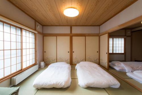 Ένα ή περισσότερα κρεβάτια σε δωμάτιο στο Obihiro INN