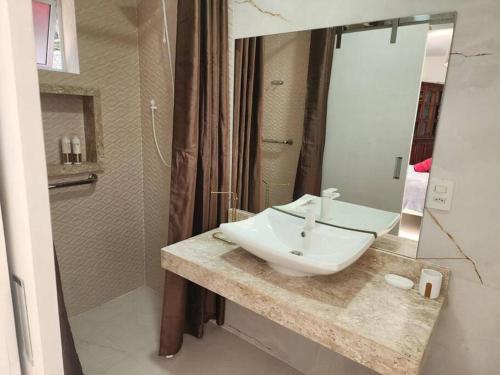 a bathroom with a sink and a mirror at Mansão Panorâmica Angra dos Reis in Angra dos Reis