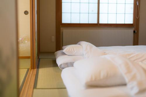 Ένα ή περισσότερα κρεβάτια σε δωμάτιο στο Obihiro INN
