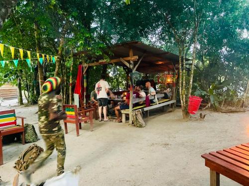 a boy riding a skateboard in front of a food stand at Land of Promise - Reggae Escape in Zanderij