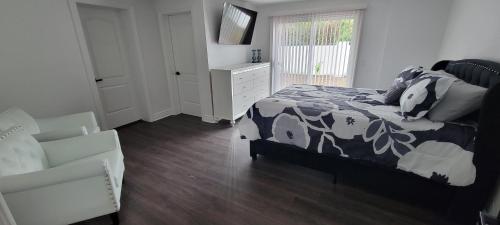 a bedroom with a bed and a dresser and a chair at Beautiful modern house in Clearwater