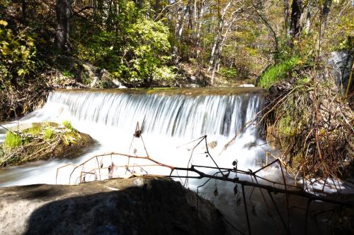 a waterfall in the middle of a river at Osceola Mill in Raphine