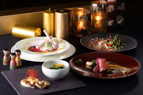 a table with plates of food on it at The Westin Sendai in Sendai