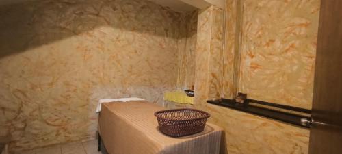 a bathroom with a bed and a basket on a table at ROSY RELAXATION HOUSE & Spa in Antigua Guatemala