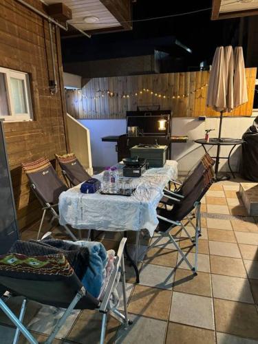 a room with a table and chairs and a piano at 트리하우스 in Suncheon