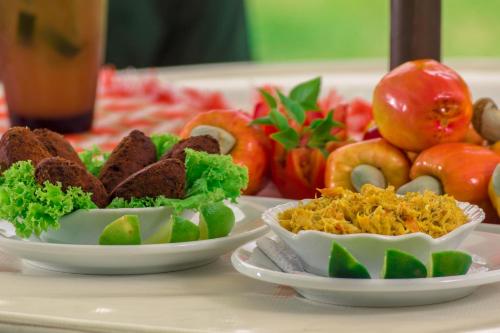 a table with two plates of food on a table at Porto Zarpa Hotel in Praia do Forte