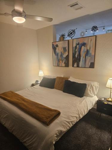 a bedroom with a large bed with white sheets and pillows at Modern Cozy Condo facing Riverwalk w King Suite in San Antonio