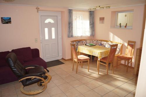 a kitchen and dining room with a table and chairs at Apartment Robert in Maiersdorf