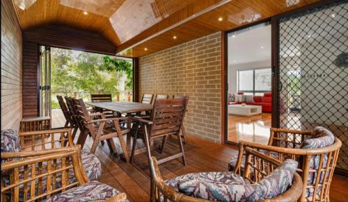 a dining room with a table and chairs at Beach front unit in Capel Sound in Capel Sound