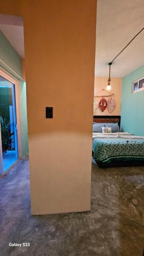 a room with a bed and a wall at Saak Luúm Ruta Puuc in Sacalum