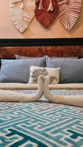 a bed with a headboard with a snake on it at Saak Luúm Ruta Puuc in Sacalum