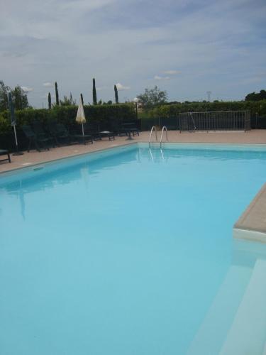 a large swimming pool in a resort at il Chiassetto Agriturismo No Kids in Cascina