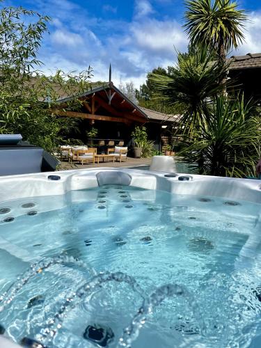 a hot tub in front of a house at VillaCanau in Lacanau