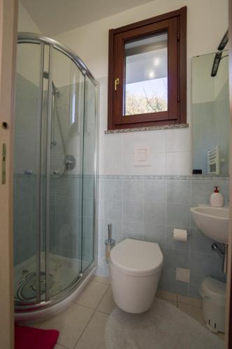 a bathroom with a shower and a toilet and a sink at Il Giardino di Valentina in Escolca
