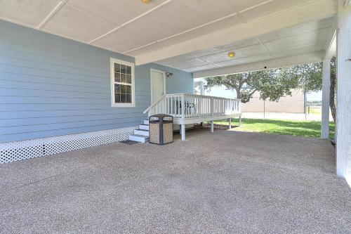 a front porch of a blue house with a staircase at Seashell Memories in Rockport