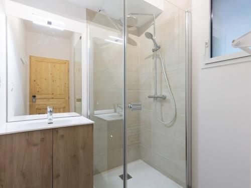 a bathroom with a glass shower and a sink at À Loudenvielle, T2 moderne, proche télécabine, parking, wifi - FR-1-695-61 in Loudenvielle