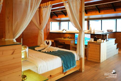 a bedroom with a bed and a desk in a room at Maliekal Heritance Cherai Beach Cochin in Cherai Beach