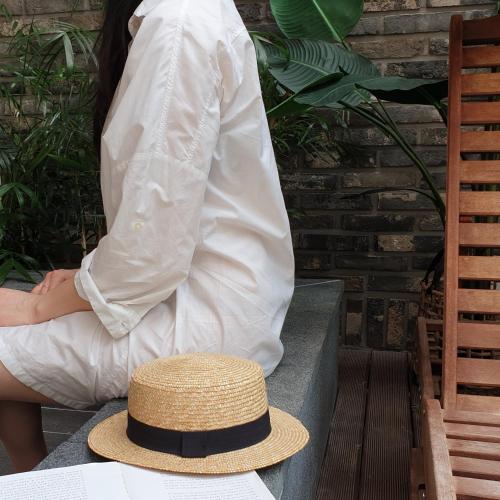 a person sitting on a bench with a hat at Gout Stay in Daegu