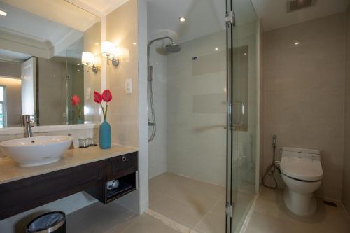 a bathroom with a toilet and a sink and a shower at La Sapinette Hotel Dalat in Da Lat