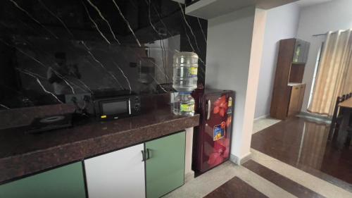 a kitchen with a counter top and a refrigerator at Peaceful Getaway in Udupi Manipal in Udupi